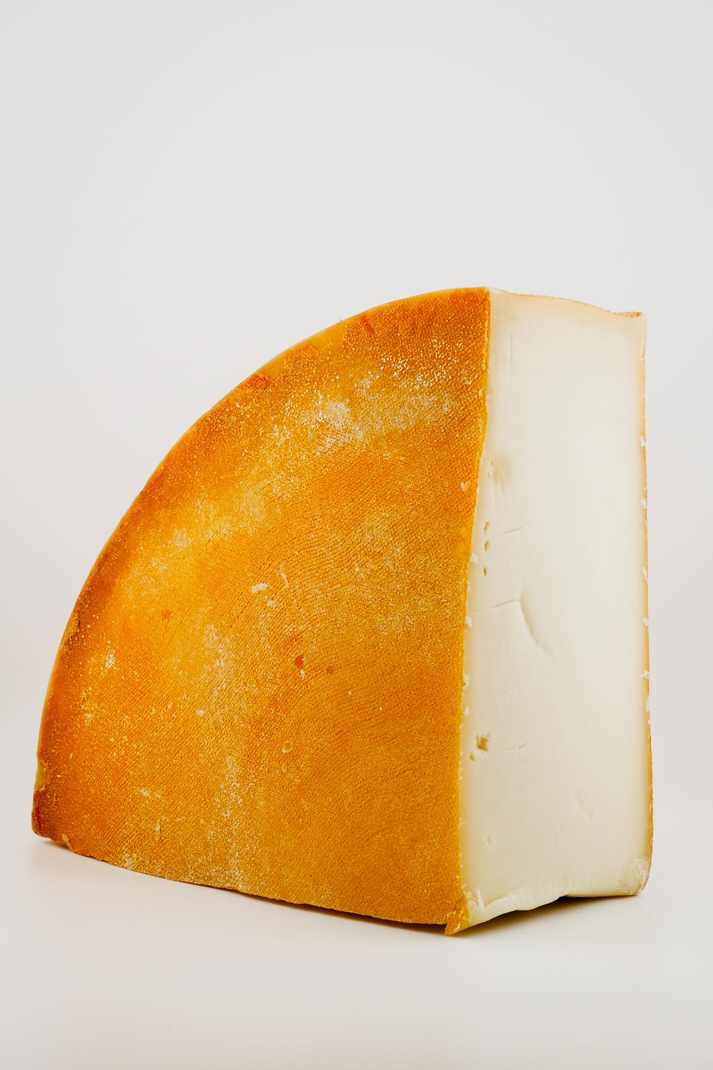 wedge of FONTAL cheese on a white background