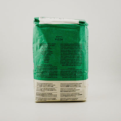 Green pizza dough package with text on a gray background