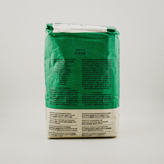 Green pizza dough package with text on a gray background