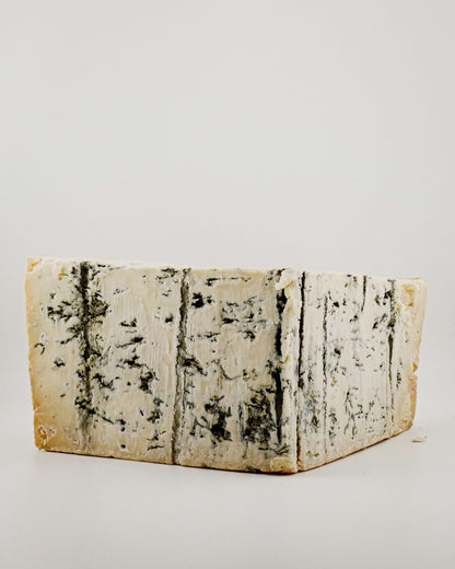 Block of blue cheese with a white background