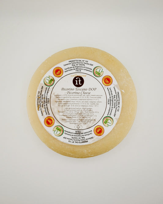 Round sheep cheese with a label on a white background
