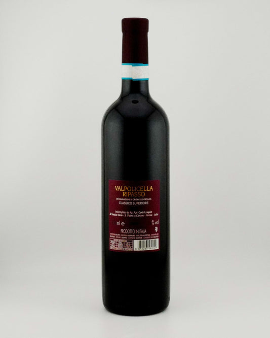 Black wine bottle with a visible label on a white background
