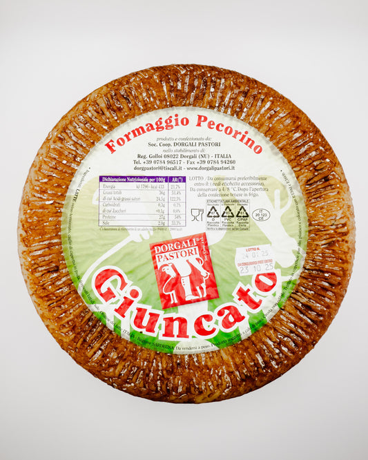 Piuncato Formaggio Pecorino cheese wheel with packaging on a white background